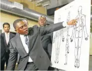  ?? THE ASSOCIATED PRESS ?? Dr. Bennet Omalu, a pathologis­t, points to a diagram showing the gunshot wounds he found on the body of police shooting victim Stephon Clark in Sacramento, Calif. Omalu spoke during a news conference Friday. He was hired for Clark’s family to conduct...