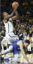  ?? TRAVIS HEYING — WICHITA EAGLE VIA AP ?? Wichita State’s Darral Willis Jr., top, is fouled by Florida Gulf Coast’s Christian Carlyle Friday in Wichita, Kan.