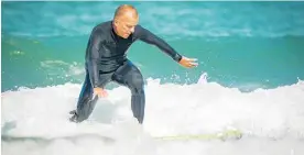  ??  ?? Pete Young, from one of the programmes sponsor’s Rabobank, catches a wave.