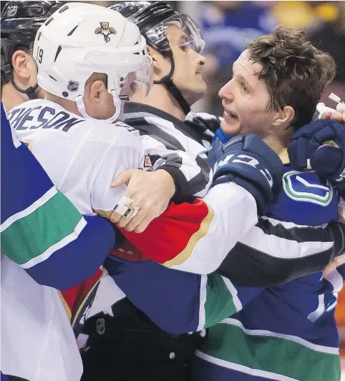  ?? ARLEN REDEKOP/PNG FILES ?? Antoine Roussel, right, wrestles with Mike Matheson of the Florida Panthers during recent action at Rogers Arena.