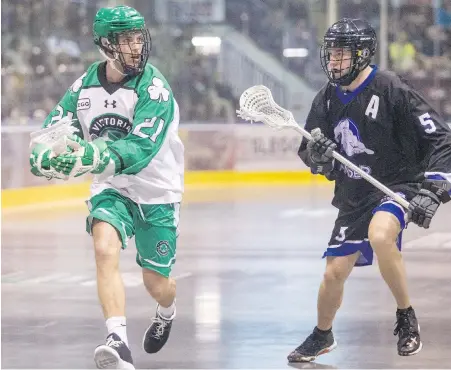  ?? DARREN STONE, TIMES COLONIST ?? Victoria Shamrocks’ Casey Jackson moves past the Langley Thunder’s Adam Will in WLA action at The Q Centre last May. Jackson is coming off a successful season in the profession­al National Lacrosse League with the Vancouver Stealth.