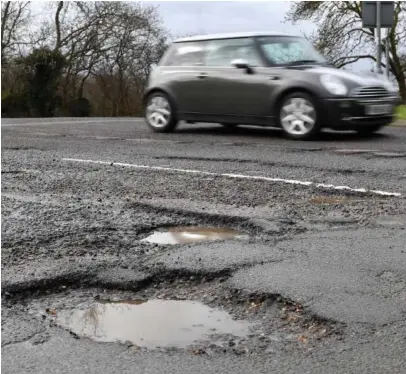  ?? ?? Potholes have long been a problem for motorists in towns and villages across Renfrewshi­re