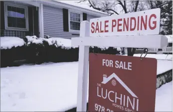  ?? AP PHOTO/CHARLES KRUPA ?? A “Sale Pending” sign is shown on an existing real estate sign, on Feb. 27 in Salem, N.H. .