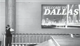  ?? Tribune News Service file photo ?? C.F. Wimbish stands in a baggage claim area in October at Love Field in Dallas. Airlines are competing for new talent after shedding workers in the pandemic.