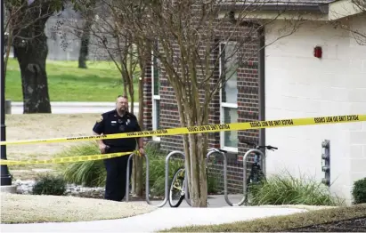  ?? AP ?? FATAL SCENE: A police officer works at the Pride Rock residence hall at Texas A&M-Commerce after a deadly shooting Monday.