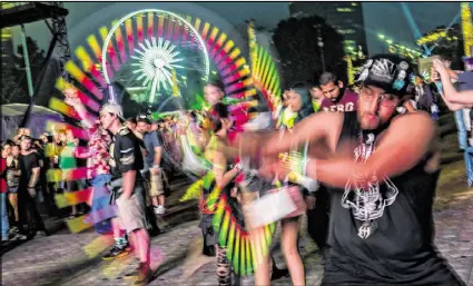  ?? JONATHAN PHILLIPS / SPECIAL 2016 ?? Jullian Darth-Faust spins glow sticks as Duke Dumont performs during the first night of the Shaky Beats Music Festival in May at Centennial Olympic Park in Atlanta.