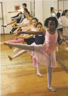  ?? ASSOCIATED PRESS FILE PHOTO ?? Children do stretching exercises at the balancing bar during a ballet class. Dance is a superb art, but there is a small window of time in which kids can simply bloom. The best dance class will offer your child a box of scarves and a wide variety of music rather than dress codes and static body positions.