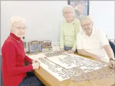  ?? LYNN KUTTER ENTERPRISE-LEADER ?? Agnes Long, left, Dorothy Staub and Delmar Lombard work on a puzzle at the Lincoln Senior Center. The center has daily activities and a hot meal Monday-Friday. It’s open for senior adults 60 years and older.