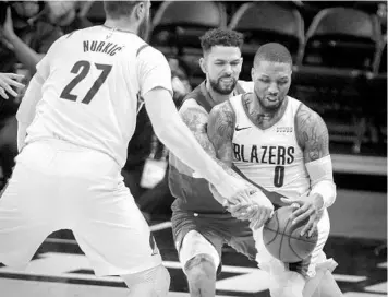  ?? JOE MAHONEY/AP ?? Denver Nuggets guard Austin Rivers, of Winter Park, back, has his hands full in defending Portland Trail Blazers scoring machine Damian Lillard, right, in an NBA first-round playoff series that goes to Game 6 on Thursday night.