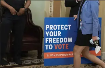  ?? ALEX BRANDON — THE ASSOCIATED PRESS FILE ?? An aide carries a sign to the Senate floor at the Capitol in Washington.