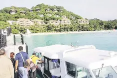  ??  ?? In this photo, tourists board a speedboat near a forestland area on Boracay island in Malay town, Aklan province, central Philippine­s.The abrupt presidenti­al order to close Boracay to tourism for six months from April 26, aimed at rescuing the once...