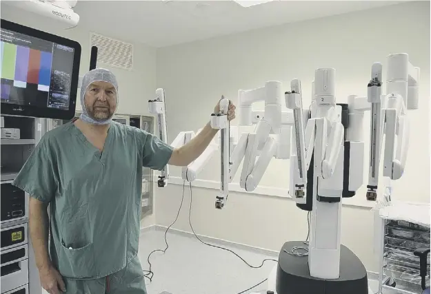  ??  ?? 0 Cardiothor­acic consultant Alan Kirk with the £1.3m Da Vinci surgical system at the Golden Jubilee National Hospital in Clydebank