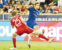  ?? — AFP photo ?? Chelsea’s Marco Alonso (R) and Bayern Munich’s Thomas Mueller (L) vie for the ball during the Internatio­nal Champions Cup football match between Chelsea and Bayern Munich in Singapore on July 25, 2017.