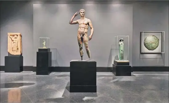  ?? Tahnee L. Cracchio Getty Museum ?? CLASSICAL GREEK “Statue of a Victorious Youth,” circa 300-100 BC, also known as the Getty bronze, is with other objects of its period in the reinstalle­d Getty Villa.