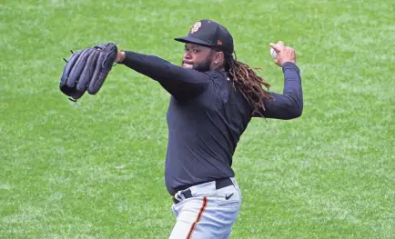  ?? KELLEY L COX/USA TODAY SPORTS ?? San Francisco Giants pitcher Johnny Cueto throws during practice Friday at Oracle Park. The shorter season might allow him to avoid problems while coming back from an elbow injury.