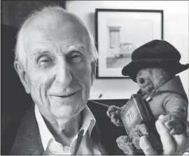  ??  ?? Michael Bond poses with a soft toy version of Paddington bear in 2015. Publisher HarperColl­ins says Bond, creator of the globe-trotting teddy bear, died on Tuesday. THE ASSOCIATED PRESS FILE