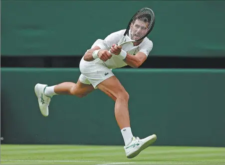  ?? REUTERS ?? Novak Djokovic scrambles across court to reach a return during his first-round match against Kwon Soon-woo at Wimbledon on Monday. Three-time defending champion Djokovic prevailed 6-3, 3-6, 6-3, 6-4 on Centre Court.