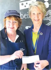  ??  ?? Carol Fletcher of the Cruizers club makes a donation to Beaconhill­s College head of citizenshi­p and service Clare Tuohy to be passed on the to Solar Buddy charity.