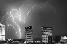  ??  ?? Lightning strikes behind Las Vegas Strip casinos as a thundersto­rm passes through Las Vegas, Nevada. Investors in ‘cat bonds’ – or catastroph­e bonds – may find themselves in financial straits after insurers tot up their losses from hurricanes Harvey...