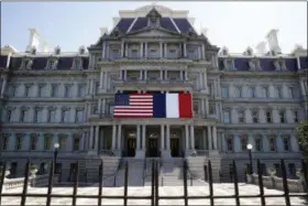  ?? ALEX BRANDON — THE ASSOCIATED PRESS ?? The U.S. and French flags are displayed on the Eisenhower Executive Office Building, Friday in Washington. President Donald Trump plans to celebrate nearly 250 years of U.S.French relations by hosting President Emmanuel Macron at a glitzy White House...