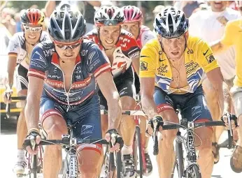  ??  ?? Floyd Landis, left, and Lance Armstrong, right, during the 2004 Tour de France.