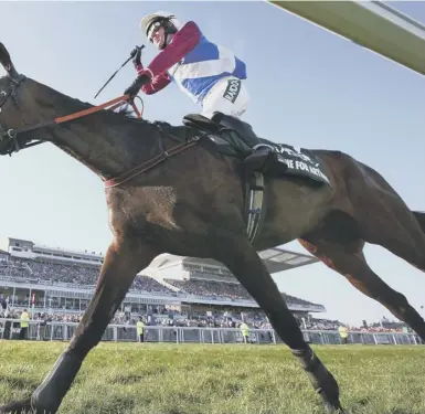  ??  ?? 0 Jockey Derek Fox celebrates as he and One For Arthur cross the line to win the 2017 Randox Health Grand National at Aintree.