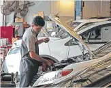  ?? Houston Chronicle file ?? Sterling McCall Toyota technician Nilson Rivera checks the oil level on a vehicle. Sterling McCall is a Group 1 dealership.