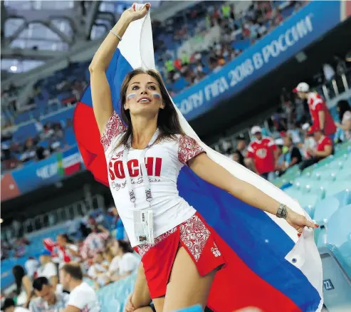  ?? PAVEL GOLOVKIN / THE ASSOCIATED PRESS ?? The influx of internatio­nal visitors for the World Cup has opened up what has been called ‘Fortress Russia’ for local women. There are reports of an 11-fold surge in the use of the Tinder dating app since the tournament began.
