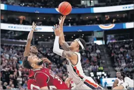  ?? [JEFF SWINGER/THE ASSOCIATED PRESS] ?? New Mexico State forward Johnny Mccants, left, defends against Auburn’s Bryce Brown during Thursday’s NCAA Tournament game.