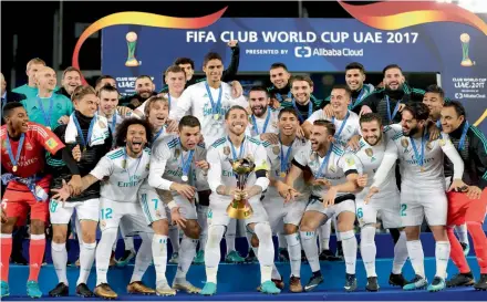  ?? AFP ?? Real Madrid’s players celebrate with the Fifa Club World Cup trophy after their 1- 0 victory in the final against Gremio FBPA at the Zayed Sports City Stadium in Abu Dhabi on Saturday. —