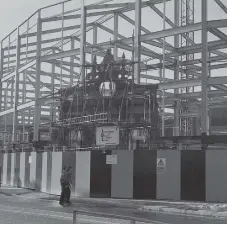  ??  ?? The ornate facade of the old High Street swimming baths dwarfed by the steel framework of the new Inland Revenue office in Sunderland.