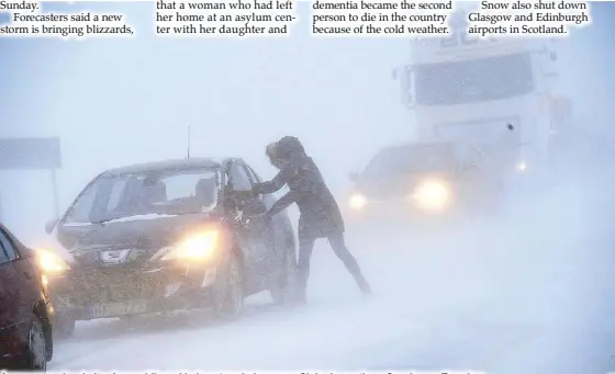  ?? AP ?? A woman seeks shelter from a blizzard in her stranded car near Sjobo in southern Sweden on Tuesday.