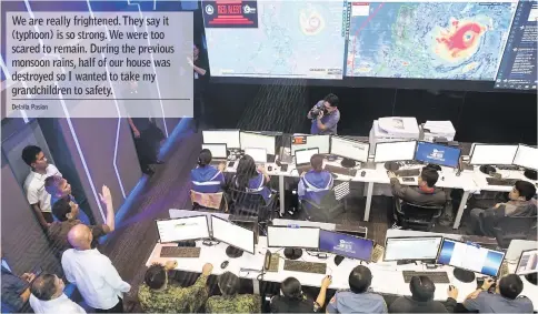  ??  ?? Duterte (fourth left, arm upraised) gestures while visiting the National Disaster Risk Reduction and Management Council (NDRRMC) Operations Centre at Camp Aguinaldo in Manila. — AFP photo