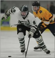  ??  ?? Kade Manzo (8) of Lake Orion carries the puck up ice in front of Rochester United’s Carson Becks during the MHSAA D1Regional final held on Friday.