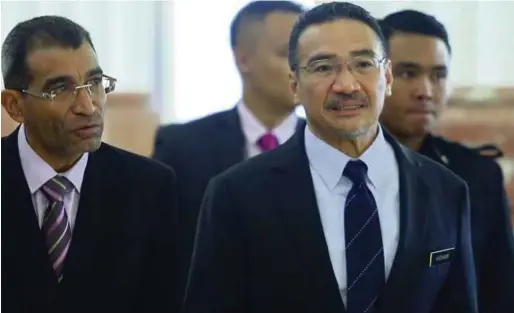  ?? PIC BY MOHAMAD SHAHRIL BADRI SAALI ?? Defence Minister Datuk Seri Hishammudd­in Hussein (right) attending a session at Parliament in Kuala Lumpur yesterday.