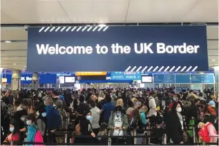  ?? (Guy Faulconbri­dge/Reuters) ?? INCOMING PASSENGERS line up at passport control at Heathrow Airport.