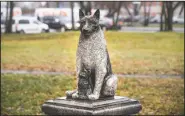  ??  ?? The statue of Zorik shows him warming up a kitten. Zorik once had a dog companion who was killed in a car accident. He then took up with stray cats and was seen with them often, even while sleeping.