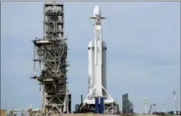  ?? TERRY RENNA — THE ASSOCIATED PRESS ?? A Falcon 9 SpaceX heavy rocket stands ready for launch on pad 39A at the Kennedy Space Center in Cape Canaveral, Fla., Monday. The Falcon Heavy blasted off Tuesday on its first test flight, carrying a red sports car aiming for an endless road trip past...