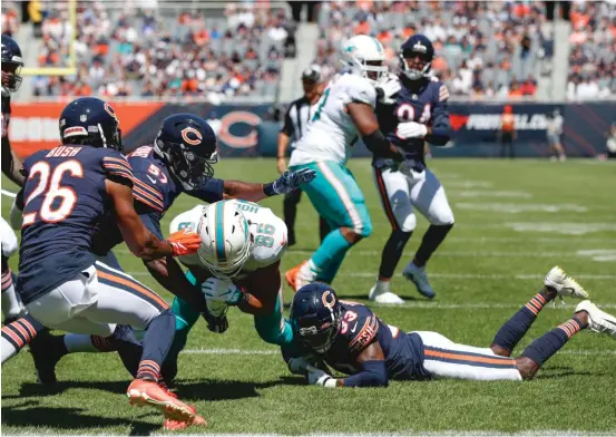  ?? AP ?? Veteran safety Tashaun Gipson believes Jaylon Johnson (33), tackling Dolphins wide receiver Mack Hollins on Saturday, will become a top-five cornerback in the NFL.