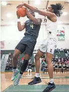  ?? JOE RONDONE/THE COMMERCIAL APPEAL ?? Whitehaven’s Kristian Spencer attempts a shot as Memphis East’s Markese Washington defends during a 2022 District 16-4A championsh­ip game.
