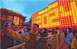  ?? ?? Visitors take photos at the Yuyuan Garden Malls yesterday. — Jiang Xiaowei