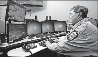  ?? [TOM DODGE/ DISPATCH] ?? Margaret Winter, a dispatcher with Columbus Division of Police, works last week on the new system that allows the public to reach 911 via a text message when a phone call isn’t possible or practical.