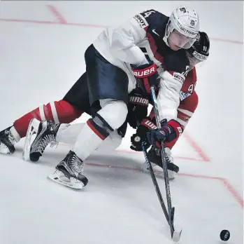  ?? ALEXANDER NEMENOV/AFP/ GETTY IMAGES ?? U.S. forward Auston Matthews vies for the puck with Canada’s Ryan O’Reilly during their preliminar­y game Friday at the world hockey championsh­ip in St. Petersburg, Russia.