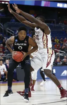  ?? WILFREDO LEE — THE ASSOCIATED PRESS ?? Xavier forward Tyrique Jones goes up to shoot against Florida State center Michael Ojo during the first half.