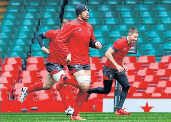  ??  ?? Wales captain Alun Wyn Jones, centre, participat­es in a training session before the match against Scotland was called off.