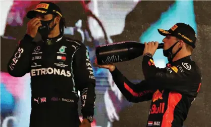  ??  ?? Red Bull’s Max Verstappen (right) and third-placed Lewis Hamilton on the podium after the Abu Dhabi Grand Prix at the Yas Marina circuit. Photograph: Getty Images