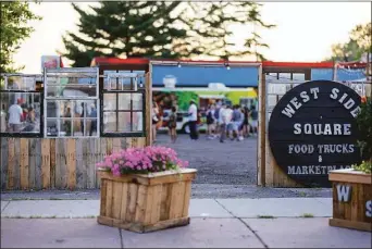  ?? ?? A fence-style structure made from old recycled windows and doors at WestSide Square, Hartford's new food truck park on Farmington Avenue.