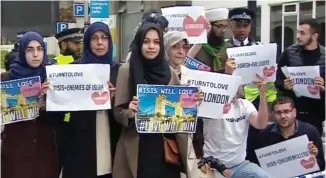  ??  ?? Protesters: Muslims hold banners in footage shared by a Twitter user