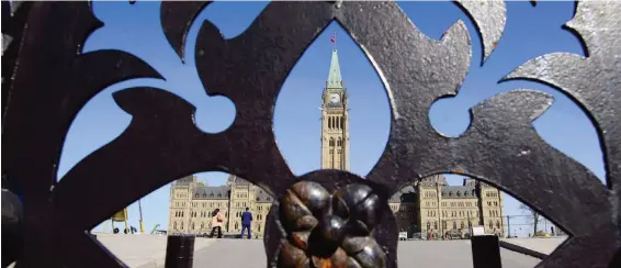  ?? THE CANADIAN PRESS ?? The Centre Block is seen from the front gates. The building has aging water, electrical and mechanical systems that are in as much need of repair as the mortar on the structure, and the building can’t meet modern technologi­cal and security demands.
