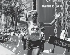  ?? PAUL RUTHERFORD TNS ?? Ethiopia’s Sisay Lemma crosses the finish line Monday to win the men's division at the Boston Marathon. Kenya’s Hellen Obiri won the women’s race for the second straight year.